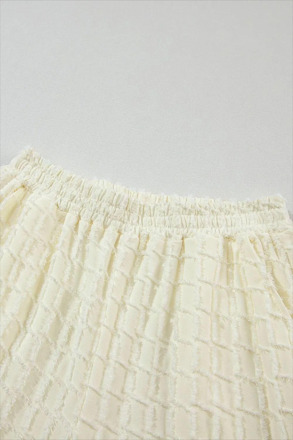 Cream-colored textured cotton skirt from Daverri set with elastic waistband