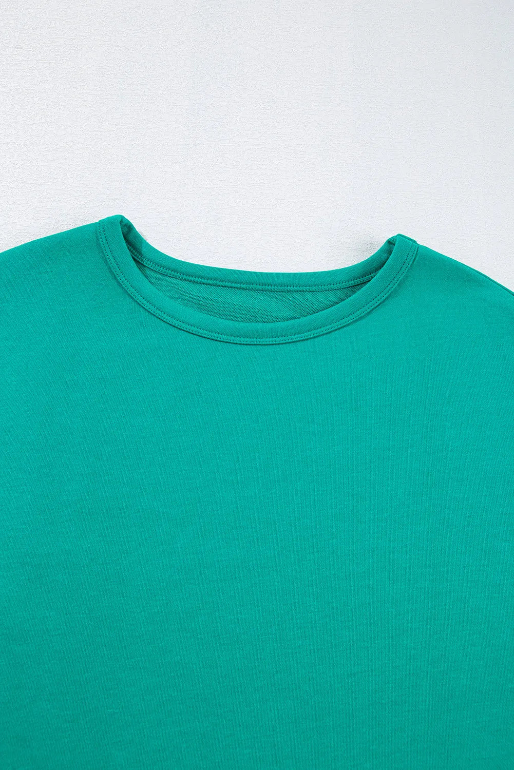 Teal crew neck t-shirt with ribbed neckline and short sleeves