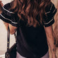 Black textured blouse with ruffled sleeves and contrast white trim