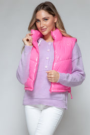 Vibrant pink glossy puffer vest with front zipper and turtleneck