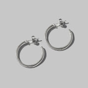 Silver textured C-hoop earrings with diamond accents in 925 sterling silver