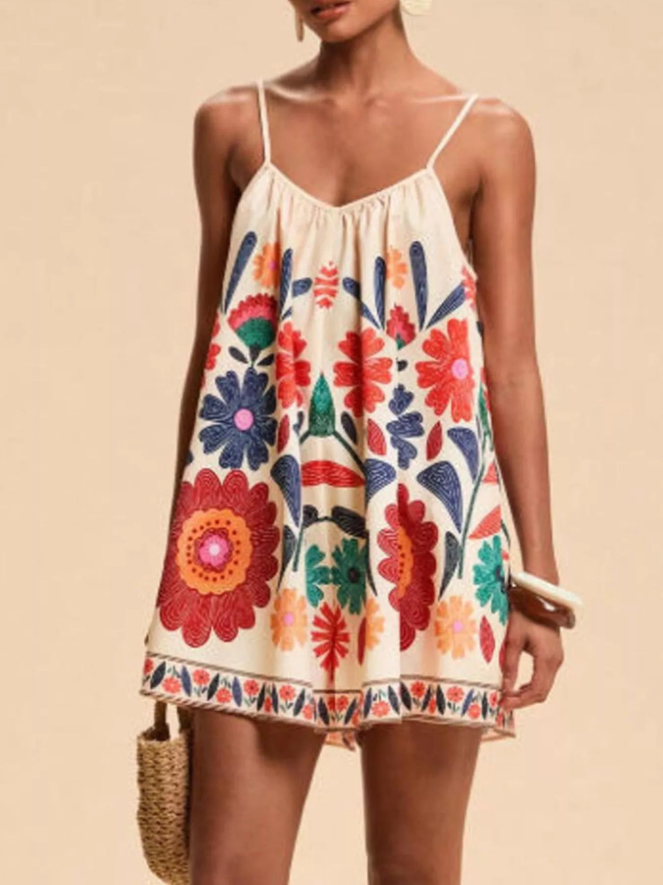 Vibrant off-white floral spaghetti strap romper with colorful embroidered blossoms