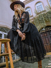 Black polka dot midi dress with floral embroidery and wide-brimmed hat