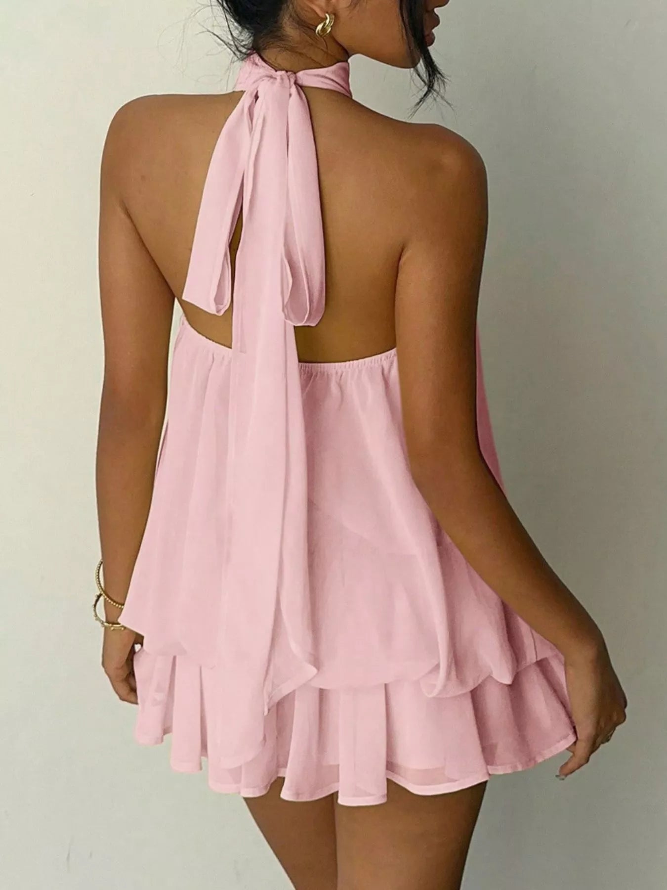 Back view of Halter Neck Ruched Mini Dress in soft pink with ruffles