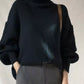 Black ribbed knit turtleneck sweater with voluminous sleeves