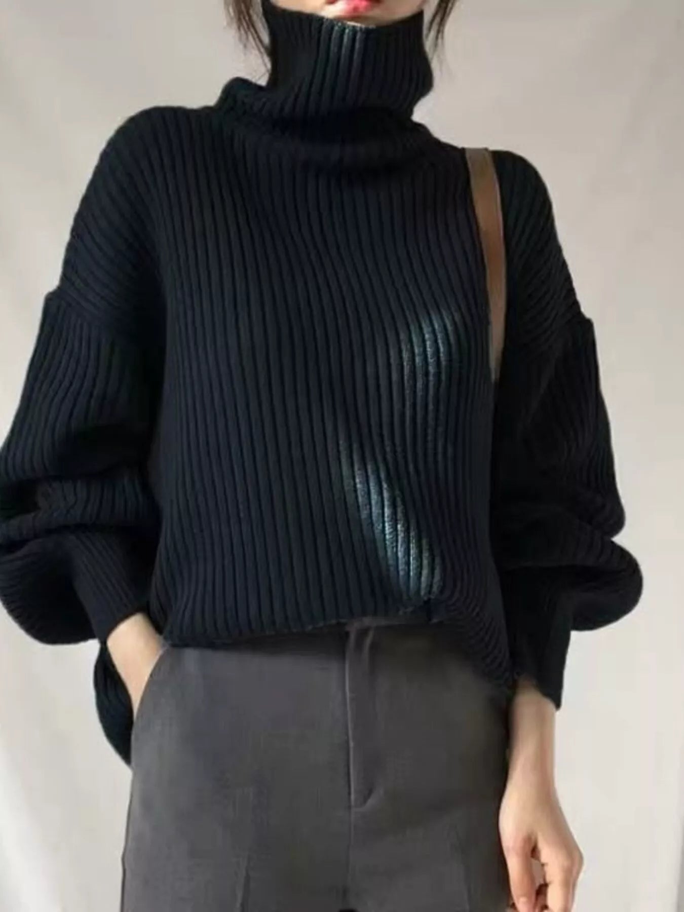 Black ribbed knit turtleneck sweater with voluminous sleeves