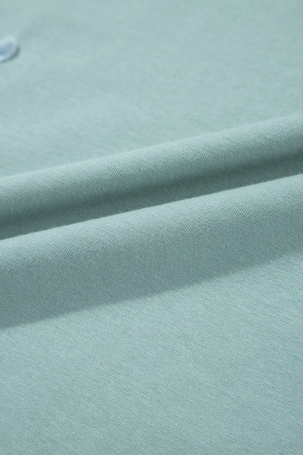 Soft mint green knit fabric with textured weave on Frayed Denim Star Patched Oversize T Shirt