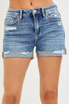 RISEN Mid Rise Cuffed Shorts in distressed blue denim with frayed edges