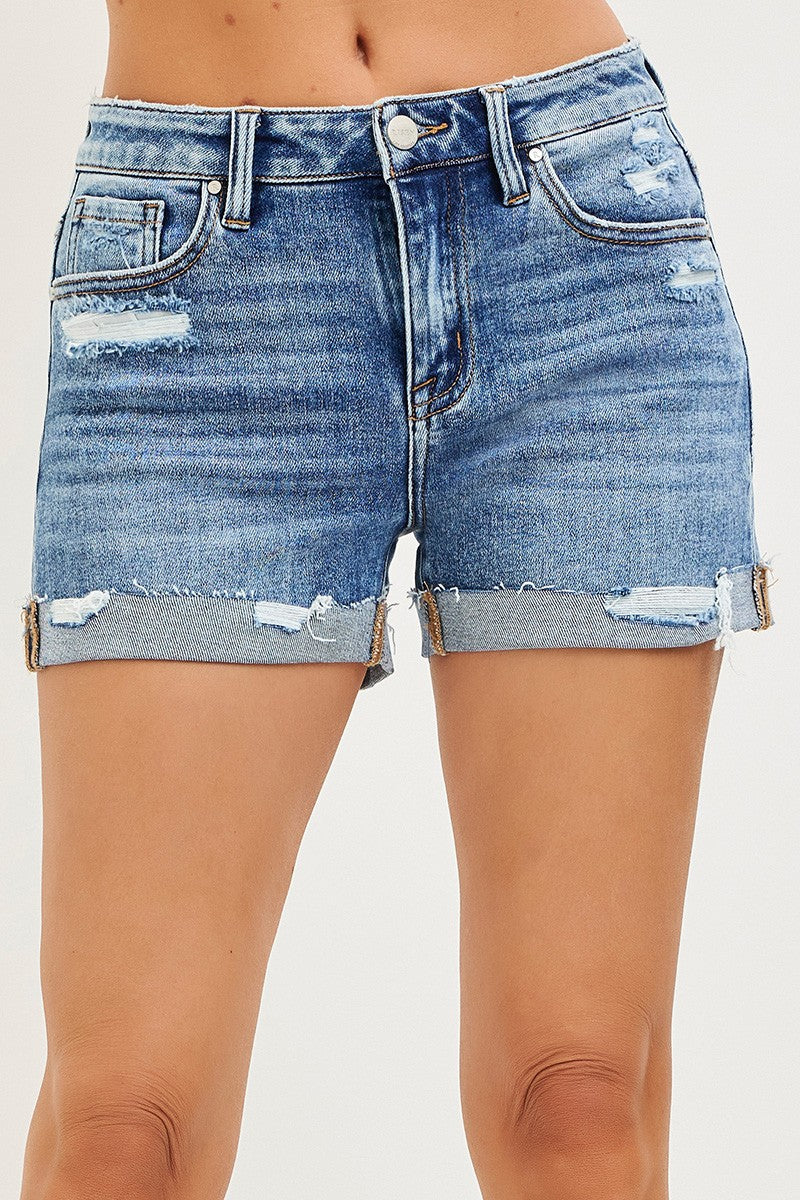 RISEN Mid Rise Cuffed Shorts in distressed blue denim with frayed edges
