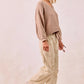 Beige ribbed knit v-neck sweater with BiBi drawstring striped twill pants