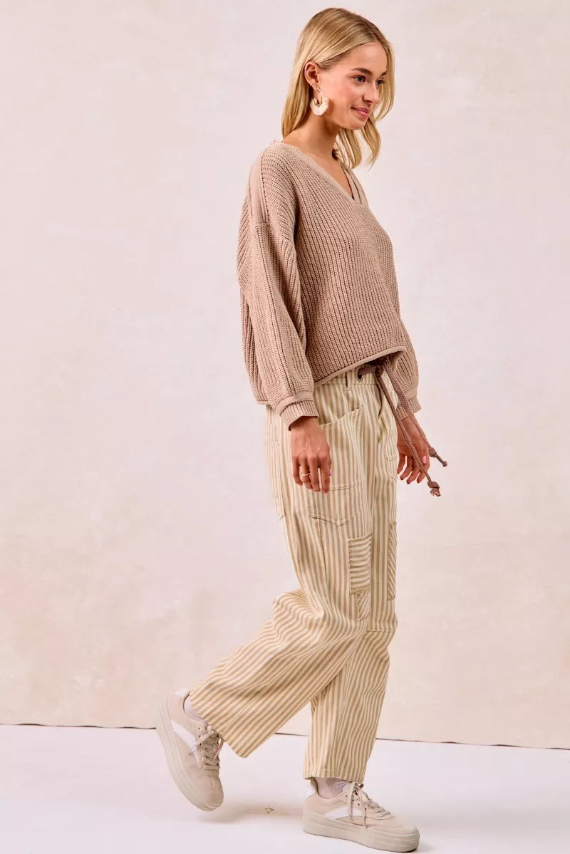 Beige ribbed knit v-neck sweater with BiBi drawstring striped twill pants