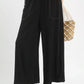 Umgee Linen Frayed Side Pocket Wide Leg Pants with black wide-leg design, white stitching and beaded trim
