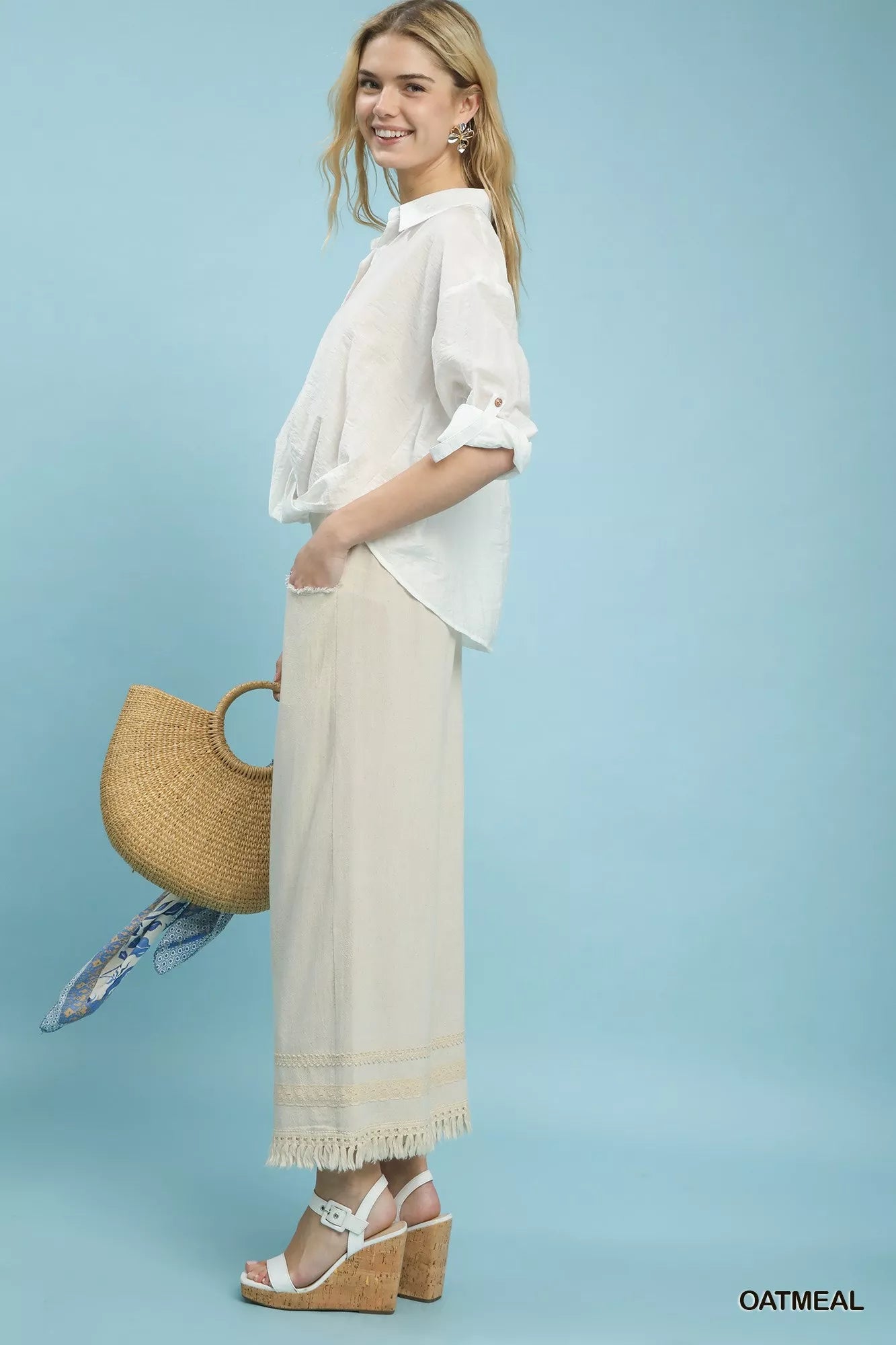Woven straw tote with blue scarf on Umgee linen pants