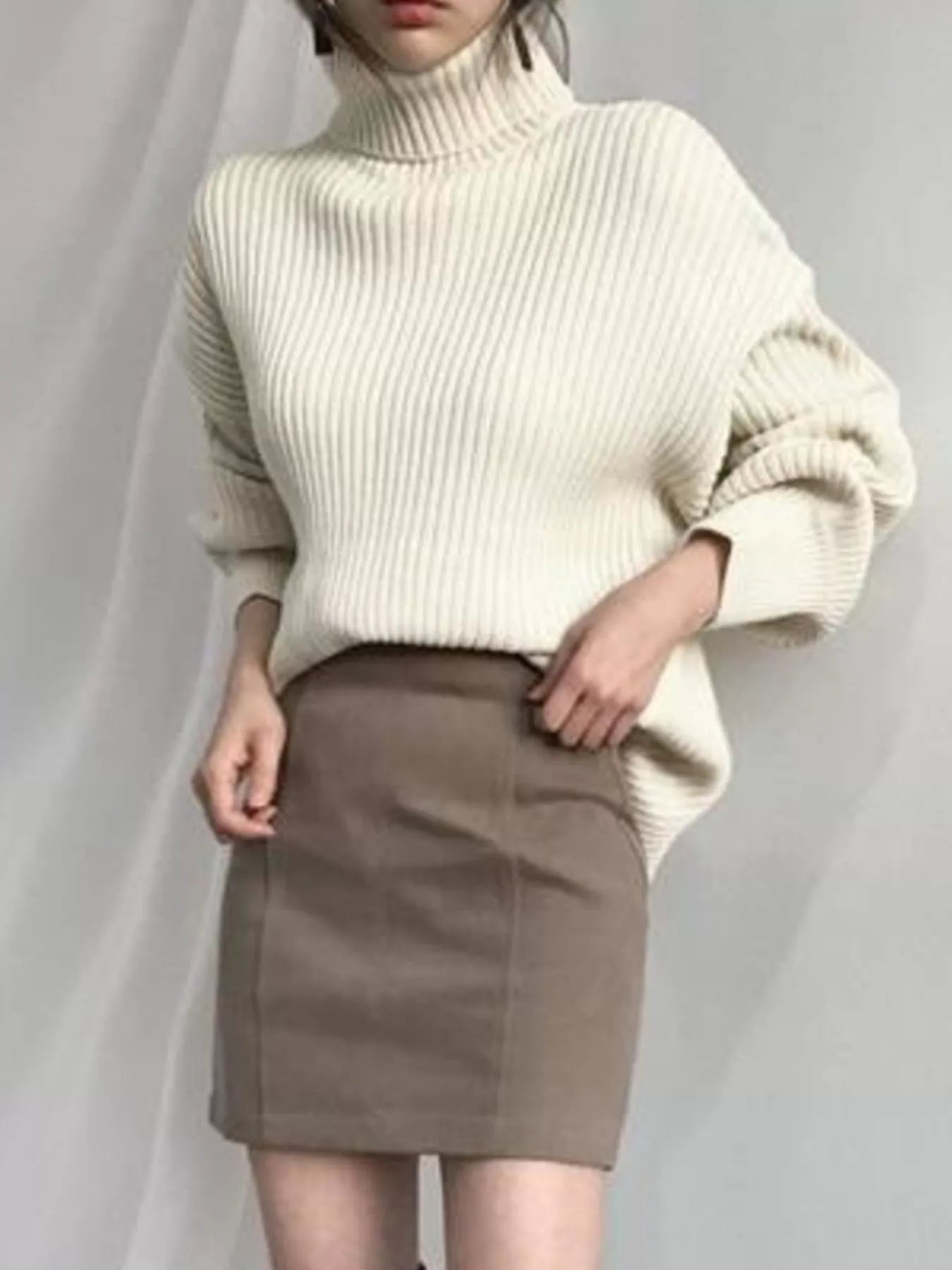 Cream-colored oversized ribbed knit turtleneck sweater plus size
