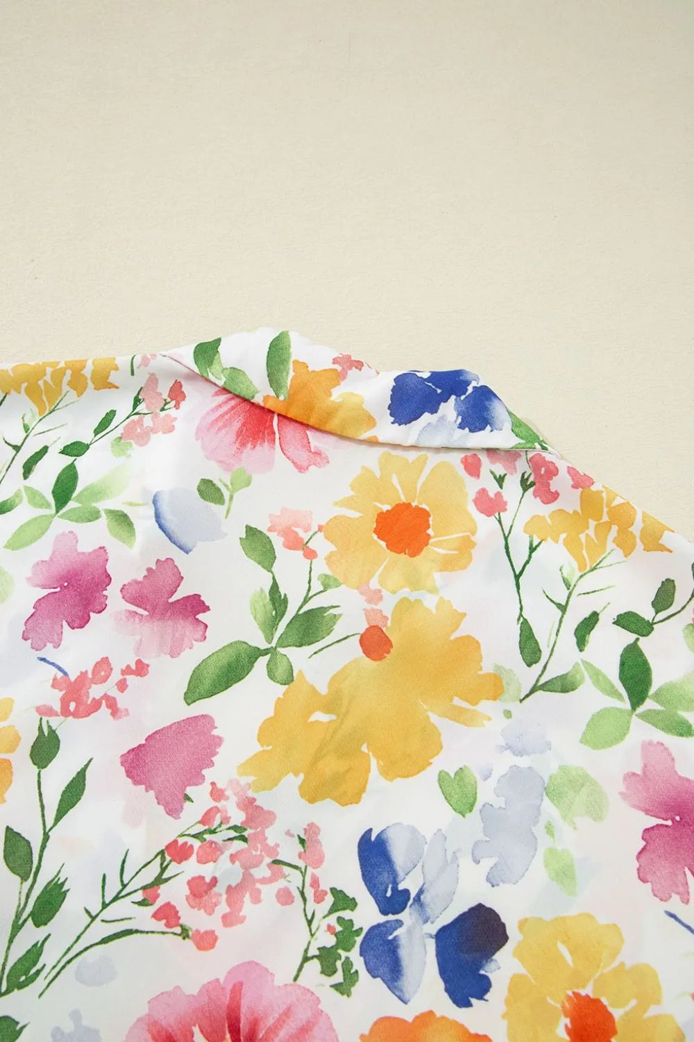 Floral boxy fit ruffled short sleeve blouse with vibrant watercolor flowers