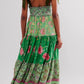 Floral tiered maxi dress in vibrant green with pink gold accents smocked waist