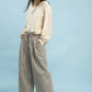 Woman in Umgee drawstring striped wide-leg pants with black and beige stripes