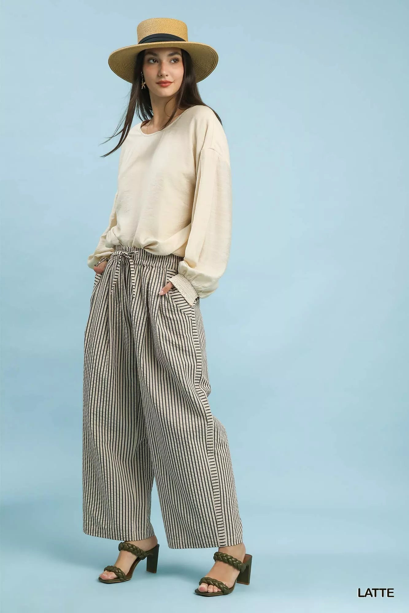 Woman in Umgee drawstring striped wide-leg pants with black and beige stripes