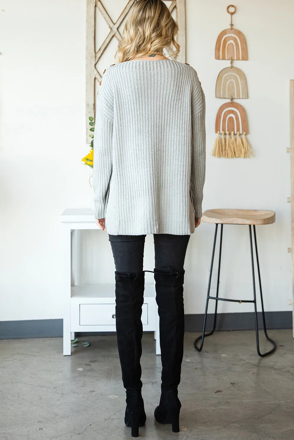 Grey ribbed knit boat neck sweater with side slit, black over-the-knee boots, sheer pantyhose