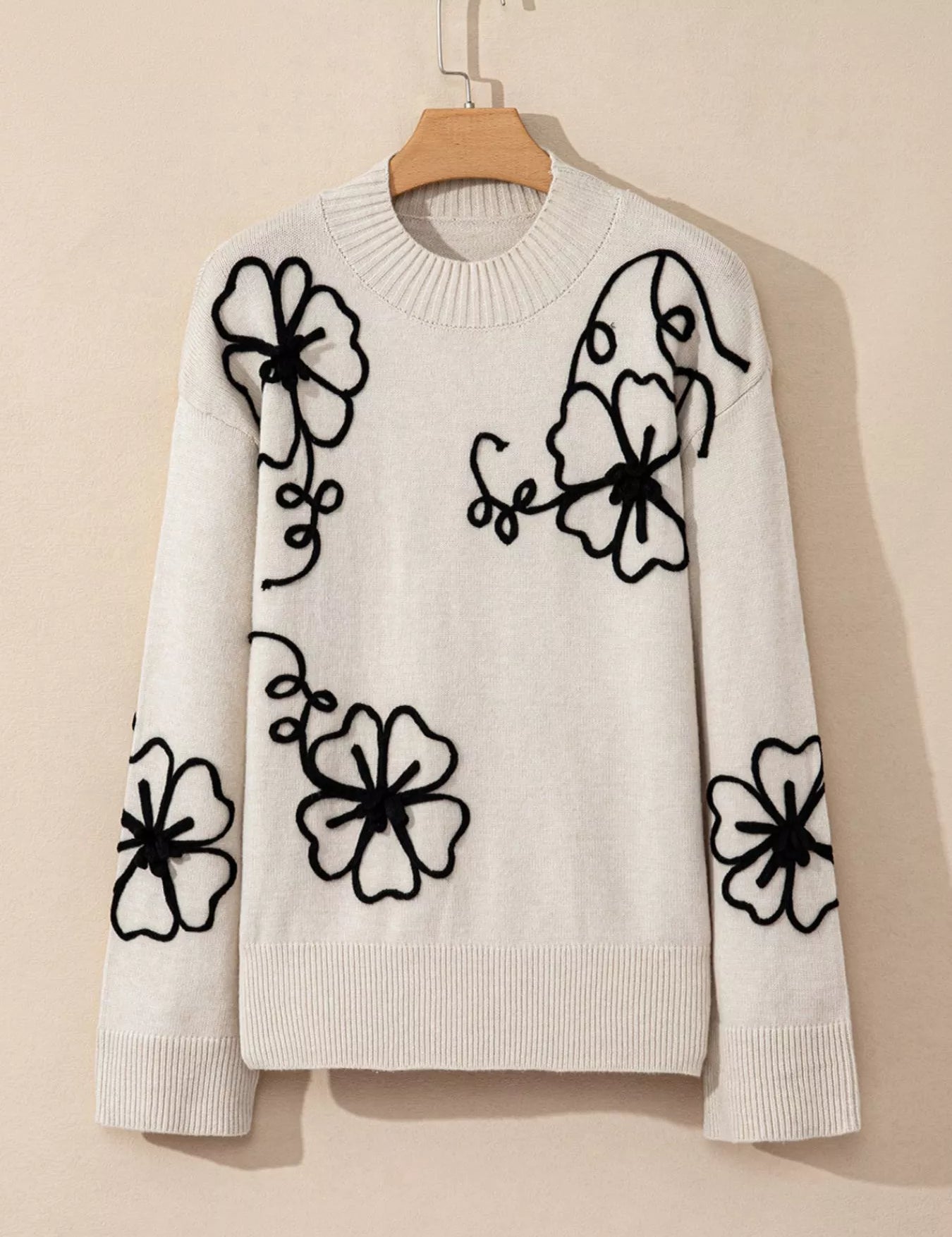 White floral embroidered mock neck sweater with black details