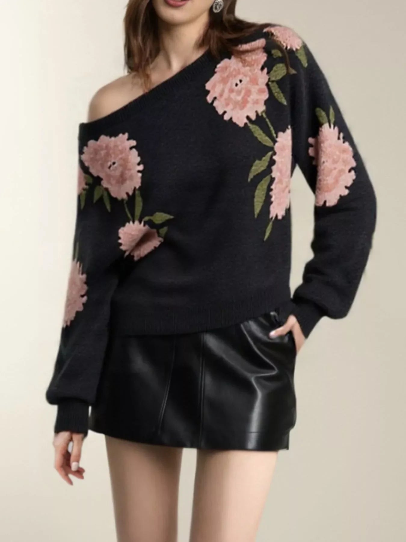 Black floral one-shoulder sweater with pink flowers and leather skirt