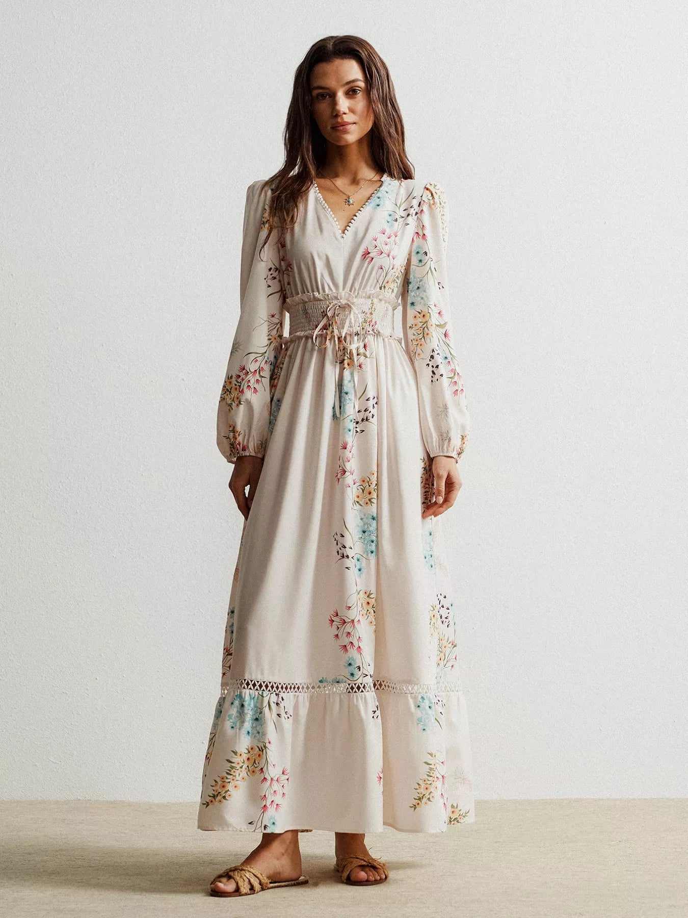 Flowing off-white floral maxi dress with long sleeves and smocked waist