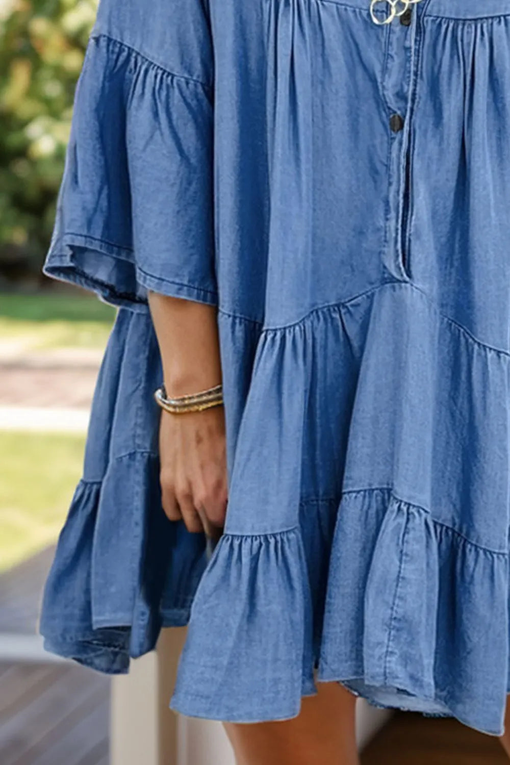 Notched flare sleeve denim dress in soft blue with tiered ruffles and button front