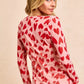 Pink long-sleeved BiBi button-down shirt with red heart print and ruched front