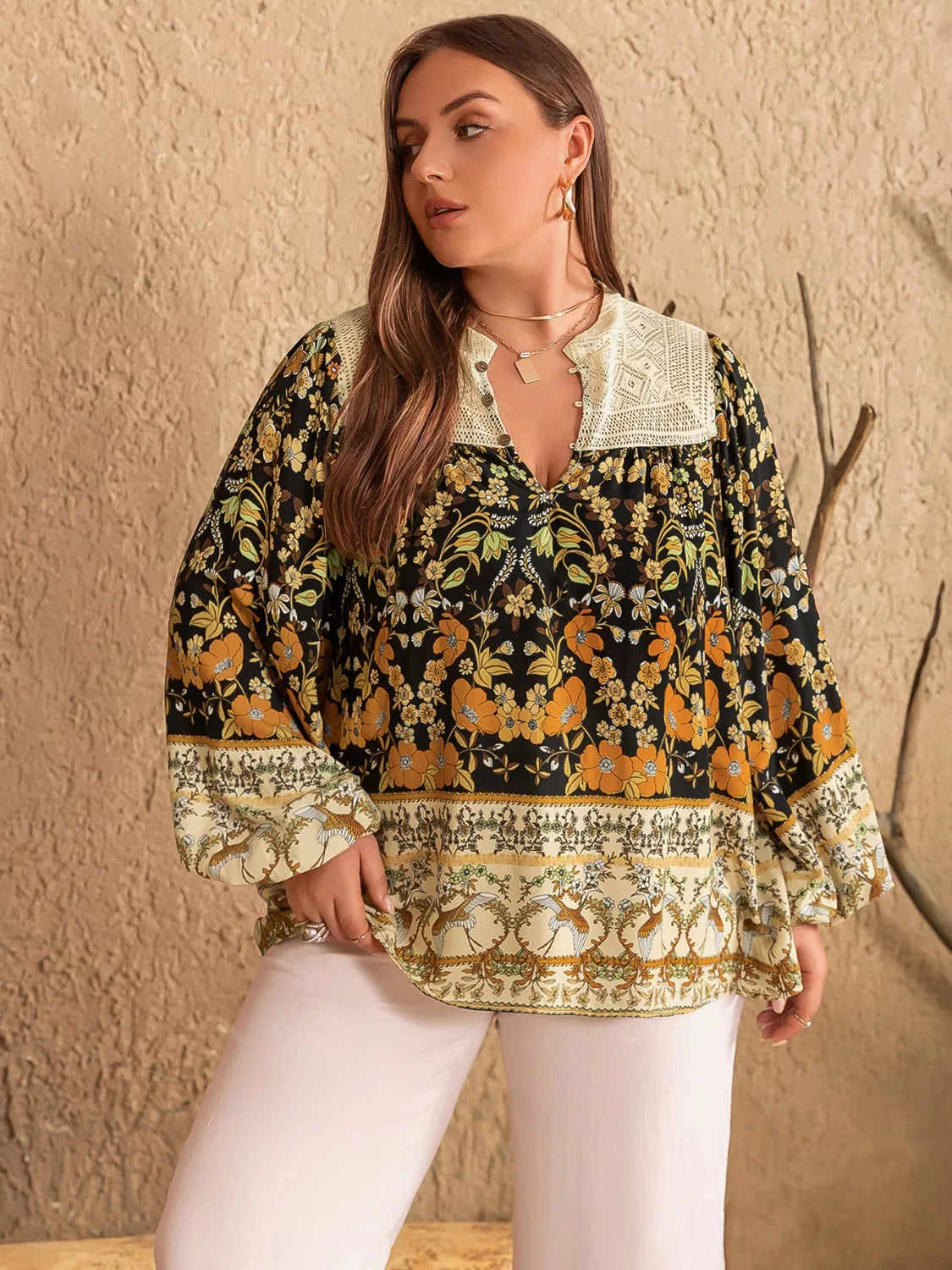 Plus size black floral print blouse with cream lace collar, cuffs, bell sleeves, V-neck