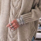 Cozy beige cable-knit long sleeve sweater with ribbed hem and cuffs