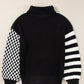Black and white striped and checkered turtleneck sweater with dropped shoulders