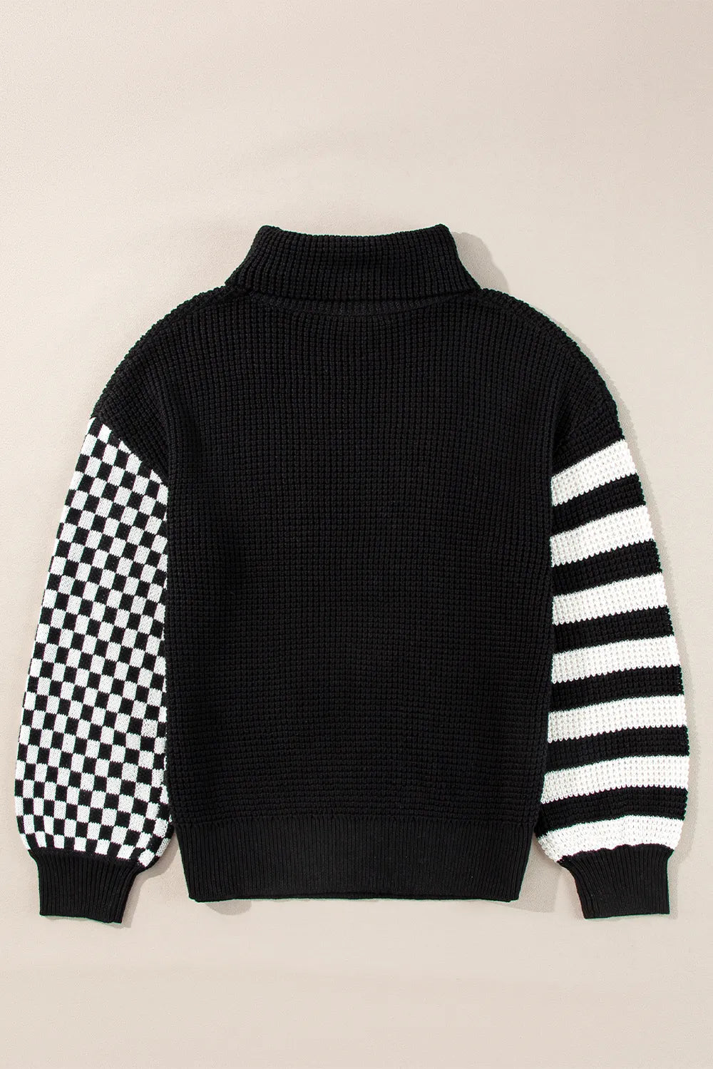 Black and white striped and checkered turtleneck sweater with dropped shoulders