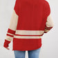 Red and cream color block knit sweater with striped sleeves