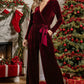 A rich burgundy velvet jumpsuit with a deep v-neckline and matching belt tied at the waist.