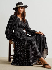 Black polka dot long sleeve maxi wrap dress with wide-brimmed hat and flip-flops