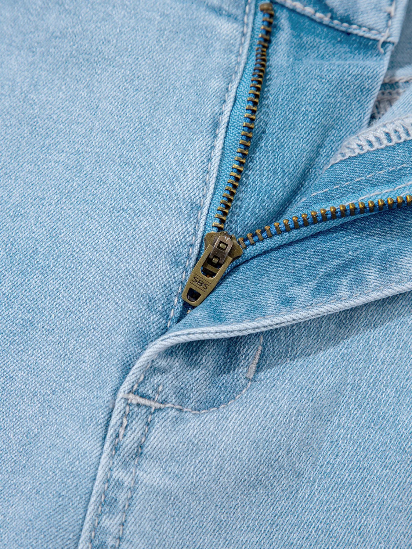 Light blue denim jacket with gold zipper on high rise jeans