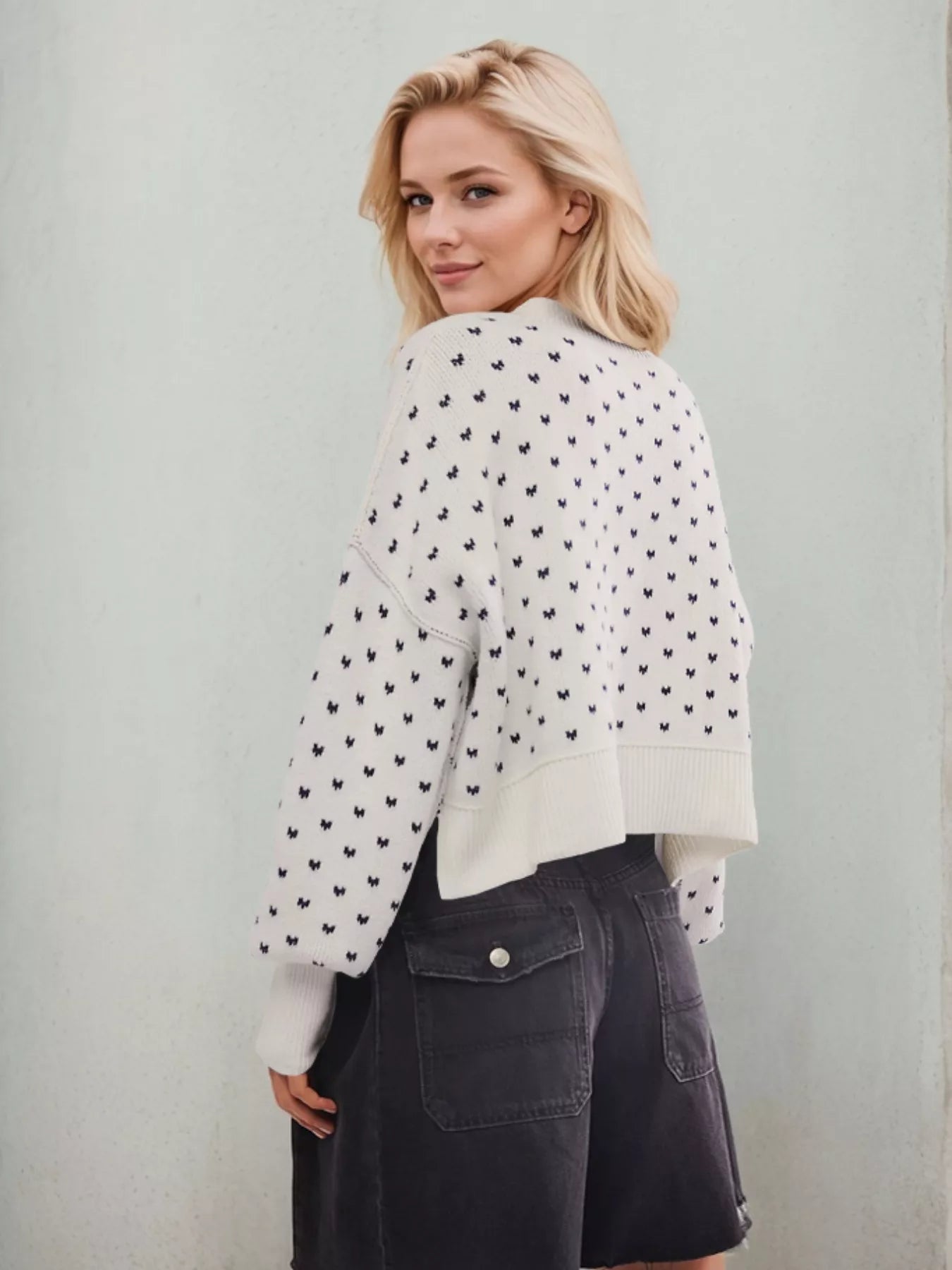 White cropped cardigan with black heart patterns from Daverri sweater