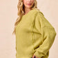 Cozy olive-green BiBi Boucle rib knit sweater with uneven hem