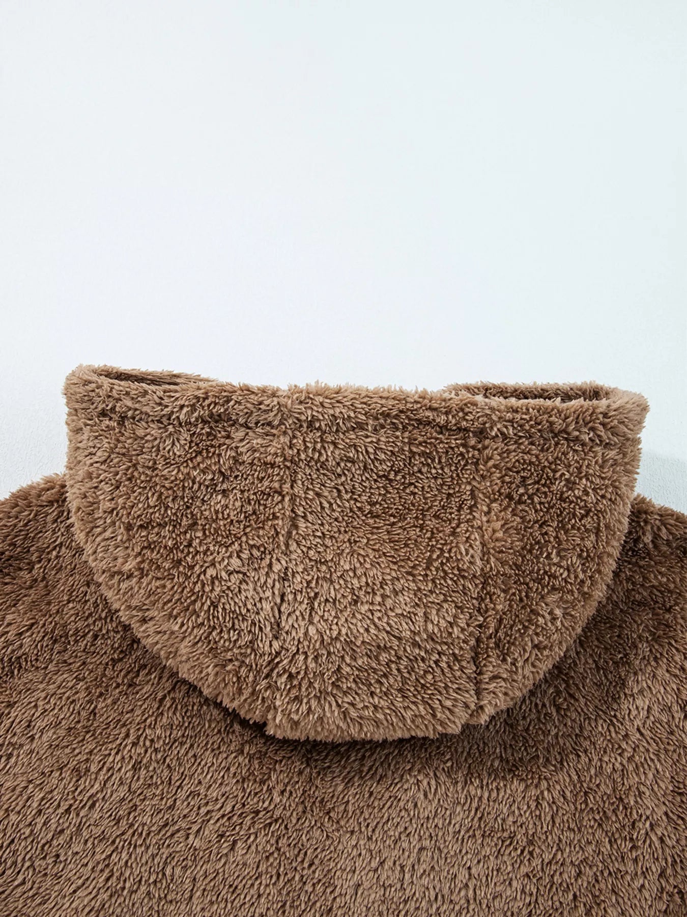 Brown fluffy turtleneck sweater with high collar and ribbed cuffs