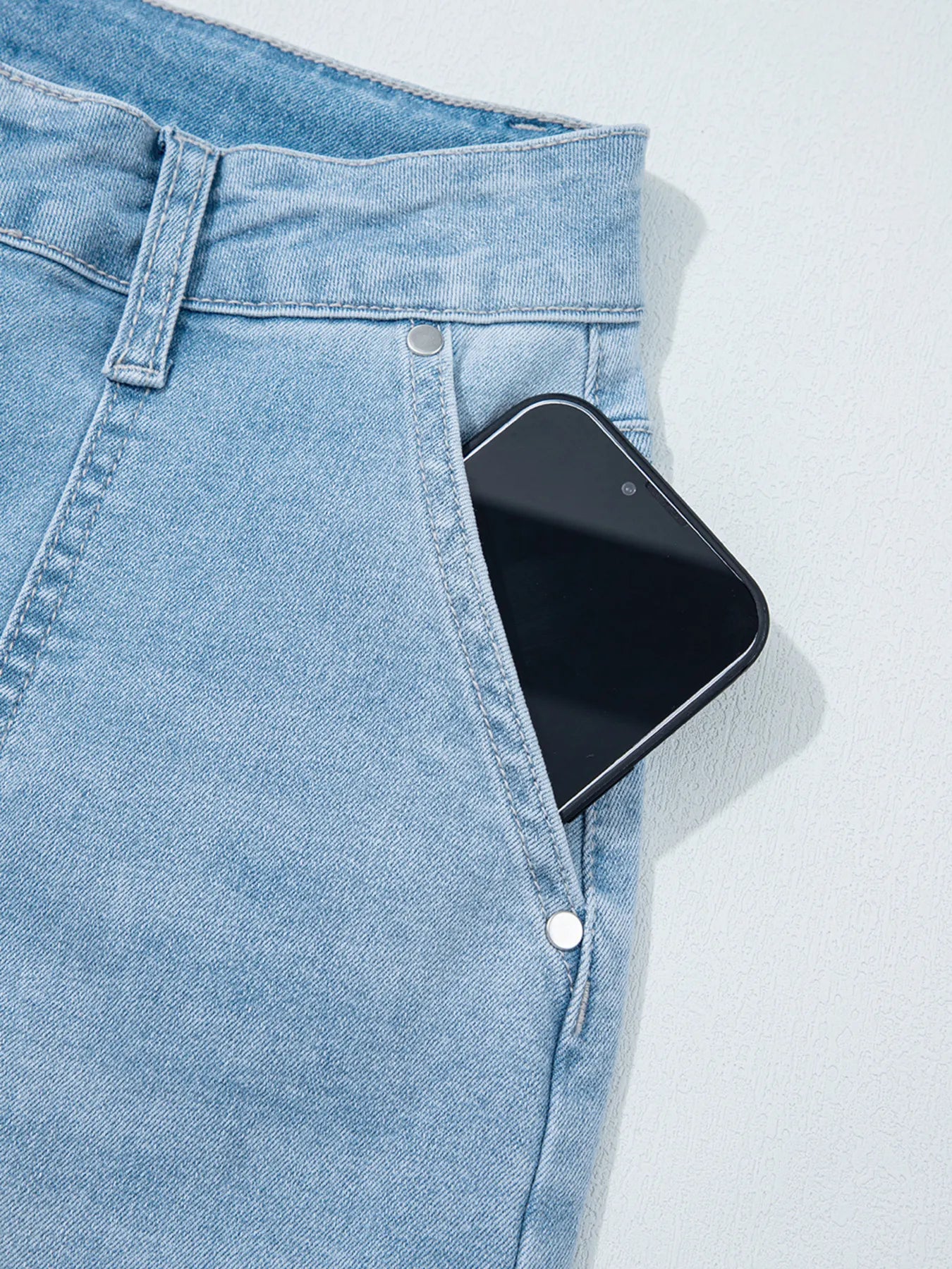 High Rise Barrel Relaxed Patch Pocket Jeans with black smartphone in pocket