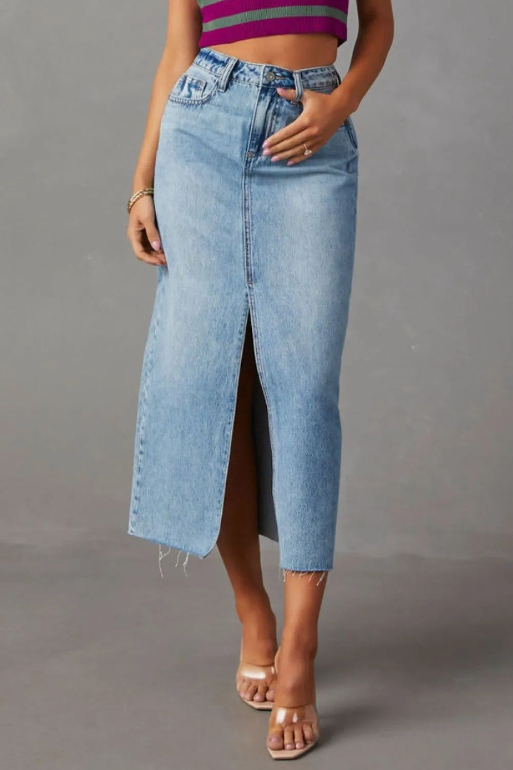 Light-wash denim midi skirt with front slit and frayed hem