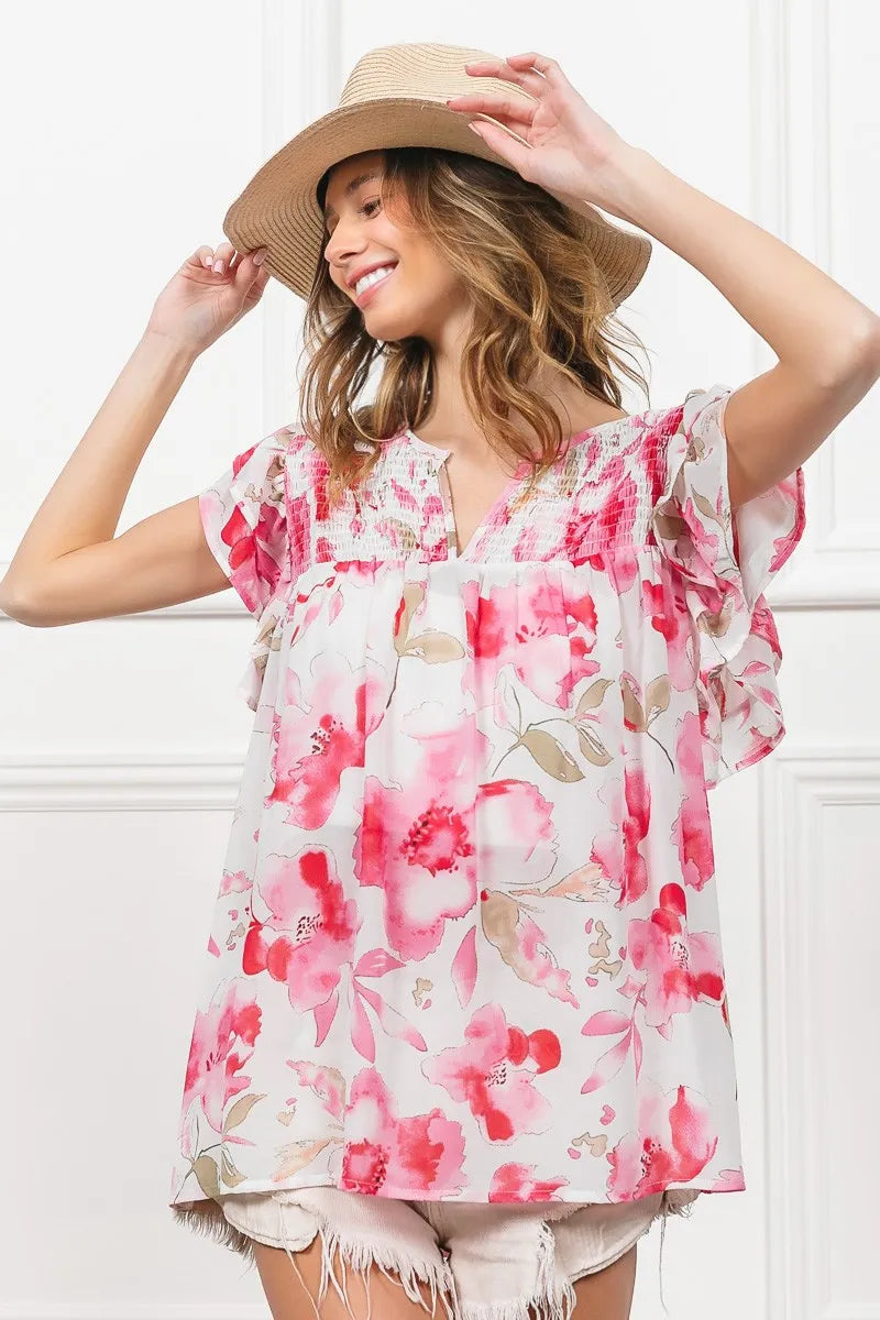 Woman in BiBi Floral Print Flutter Sheer Top with pink watercolor flowers