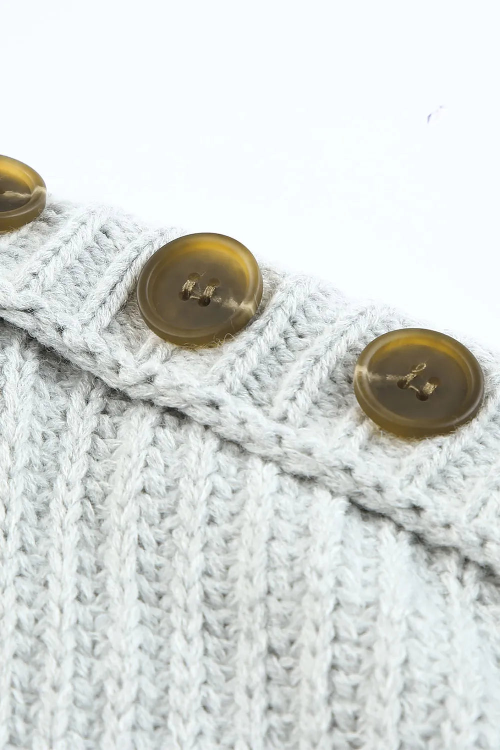 White cable knit boat neck sweater with gold buttons and side slits