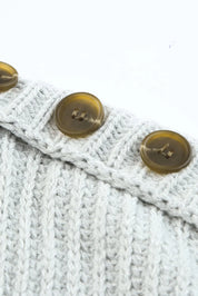 White cable knit boat neck sweater with gold buttons and side slits
