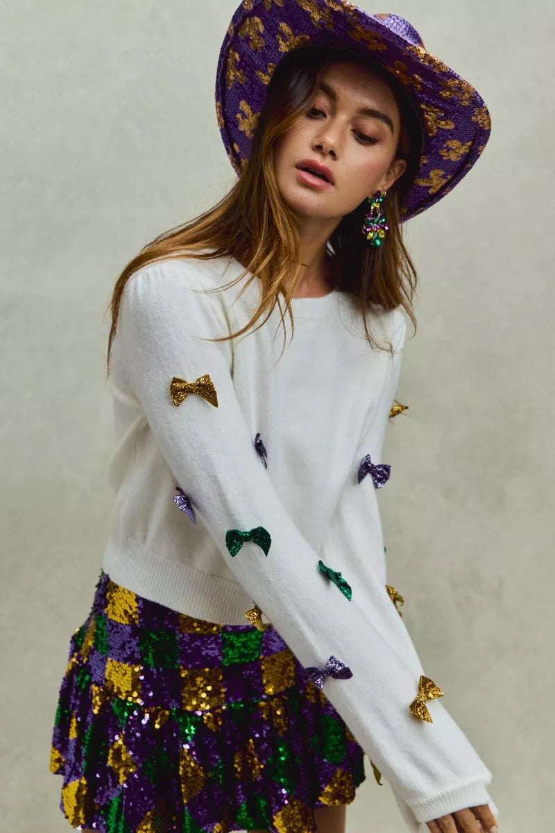 White SO ME Mardi Gras sweater with gold and purple sequined bows