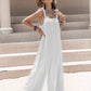 Model in flowing white sleeveless wide-leg jumpsuit with tie shoulders