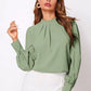 Soft sage green ruched mock neck long sleeve blouse
