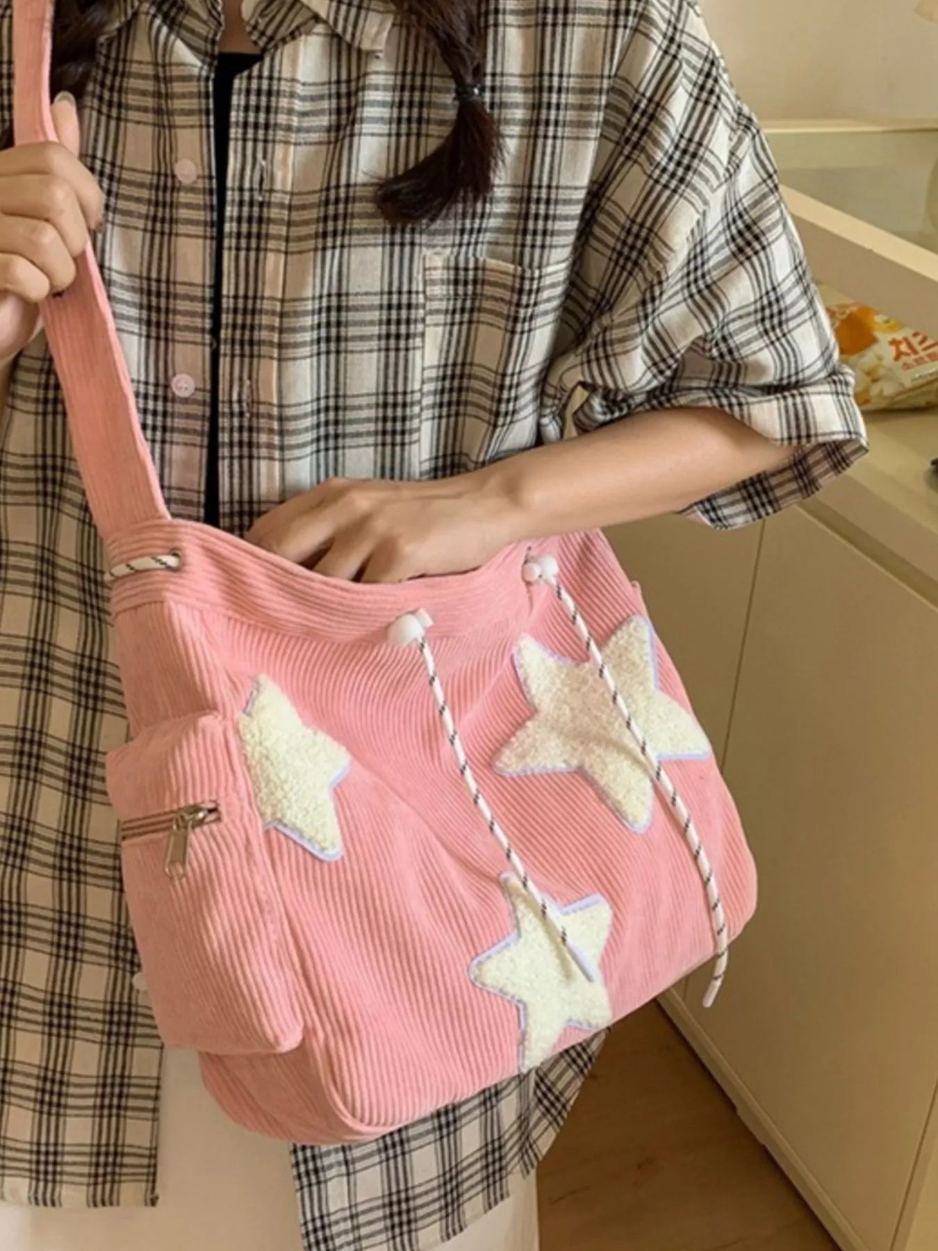 Pink corduroy star applique crossbody bag with fluffy stars and rope ties