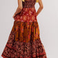Floral tiered maxi dress in rust mustard tones with gold ribbon straps