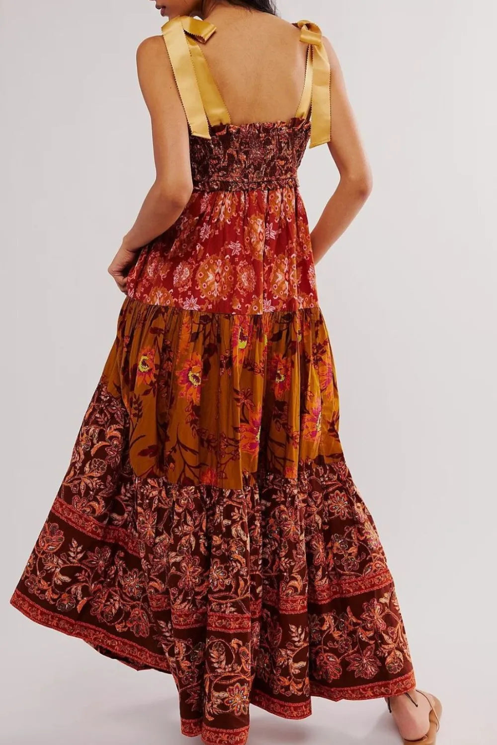 Floral tiered maxi dress in rust mustard tones with gold ribbon straps